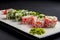 Ebiko black caviar adn red caviar sushi rolls - japanese food style. Served on a white plate over black background