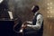 Ebony grand piano player playing on the stage