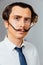 Eccentric man with a long mustache in his shirt and tie. A mad office worker, a businessman