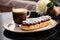 eclair and cappuccino coffee on coffee table. ai generated