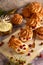 Eclairs custard cakes shu, profiteroles with strawberries on a dark background. Still life.