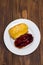 Eclairs on white dish on wooden background