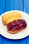 Eclairs on white dish on wooden background