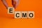 ECMO symbol. Concept words `ECMO, Extra Corporeal Membrane Oxygenation` on wooden cubes on a beautiful orange background. Male