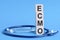 Ecmo word written on wooden blocks and stethoscope on light blue background