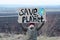 Eco activist boy holding save the planet banner. on the background of arable land. Farmland preservation concept.