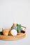 Eco cosmetics set in rattan tray. Bamboo jar or moisturizer cream, body lotion, eucalyptus leaves