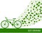 Eco driving concept in green colors. Bike and trail of tree leaves.