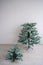 Eco-friendly artificial tree for the new year. A bare Christmas tree stands against a white wall. Traditions for a