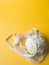 Eco-friendly beige shopping bag with cauliflower on a yellow background. String bag with vegetables. Zero waste, no plastic