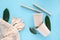 Eco-friendly biodegradable disposable cup and spoon, forks, knives, bamboo tubes, cotton string bag and dishwashing brush on a