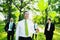 Eco-Friendly Business People Holding Green Balloons In The Woods