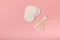 Eco-friendly cotton swab, bamboo cotton buds on a pink background.