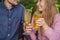 Eco friendly couple using reusable stainless steel straw to drink fruit tea