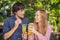 Eco friendly couple using reusable stainless steel straw to drink fruit tea