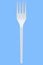 Eco-friendly disposable utensils like fork on blue background.