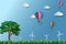 Eco friendly and environment conservation concept,colorful hot air balloon with tree flying over the meadow