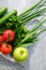 Eco-friendly grocery net bag with fresh vegetables on stone background. Healthy food shopping, zero waste concept