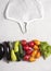 Eco-friendly mesh bag lies next to vegetables on a gray surface, copy space