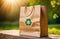 eco friendly paper bag with recycling sign at forest. packet with recycled arrows logo outdoors