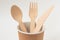 Eco friendly paper dishes. Craft cup, wooden cutlery: spoon, fork, knife. Recyclable tableware for fast food. Copy space.