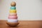 Eco friendly, plastic free toys for toddler. Stylish wooden toy for child on wooden table. Modern  wooden colorful pyramid with