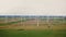 Eco-friendly power industry, scenic aerial background shot of large windmill turbine farm working in autumn field.