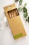 Eco friendly reusable glass straws in paper package box, bright background, top view