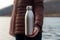 Eco-friendly stainless steel water bottle held by woman\\\'s hand