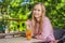 Eco friendly woman using reusable stainless steel straw to drink fruit tea