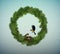 Eco green holiday idea, wreath of christmas tree branches with nest and two birds inside, sweet home, protect the forest