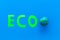 Eco icon cutout near planet Earth plastiline symbol on blue background top view space for text