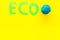 Eco icon cutout near planet Earth plastiline symbol on yellow background top view copy space
