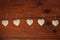 Eco linen fabric hearts on wooden background,Valentines Day concept design.Decorative white heart on jute twine garland