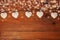 Eco linen fabric hearts on wooden background,Valentines Day concept design.Decorative white heart on jute twine garland