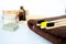 Eco natural bamboo toothbrush on white background with toiletries, natural soap, scrub, body brush and soft broun towel