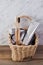 Eco natural bamboo toothbrushes and organic toothpaste in a basket in bathroom.