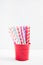 Eco paper straw with hearts in different colors in the red bucket