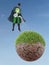 Eco superhero watering dried planet