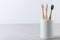Eco toothbrushes. Bamboo toothbrushes cup on gray stone background