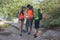 Eco tourism and healthy lifestyle concept. Young hiker girl end boys with backpack. Travelers, hikers on vacation reading a map