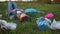 Ecological disaster, plastic pollution of the planet. A woman is lying on the grass in the middle of plastic garbage and