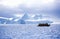 Ecological tourists in inflatable Zodiac boat in Errera Channel at Culverville Island, Antarctica