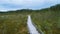 Ecological trail path - route walkways laid in the swamp. Aerial view of wooden walkway.