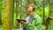 The ecologist in a forest measuring a tree trunk