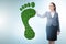 Ecology concept with green footprint and businesswoman