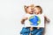 Ecology concept with two prety little kids painting earth on white background