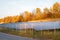 Ecology electric energy farm. Solar panels in autumn landscape. Alternative energy.