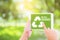 Ecology friendly recycle sign symbol with tablet holding hand