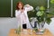 Ecology teacher with a bottle of clean water in his hands and test tubes on the table. Scientific tests and research in the school